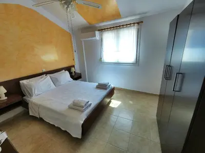 a bedroom with a bed and a window and a shower at Casa DimiGre house in Kattavia - Prasonisi Rhodes in Kattavía