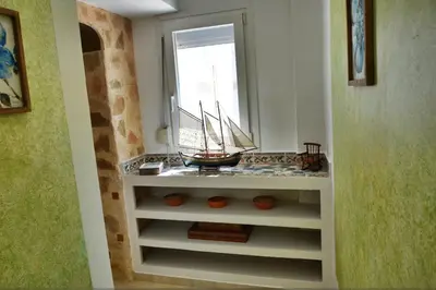 a room with a shelf with a model boat on it at Casa DimiGre house in Kattavia - Prasonisi Rhodes in Kattavía