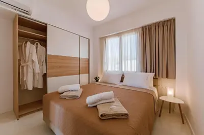 a bedroom with a large bed with two towels on it at Villa Oriens in Gennadi