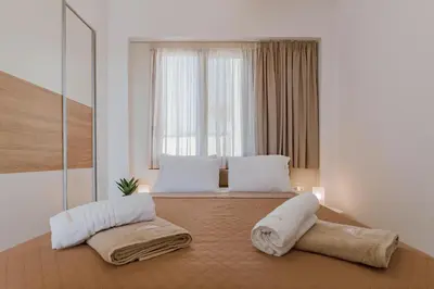 a bedroom with a bed with two pillows and a window at Villa Oriens in Gennadi