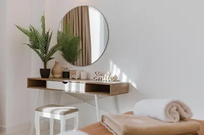 a dressing table with a mirror and a stool at Villa Oriens in Gennadi