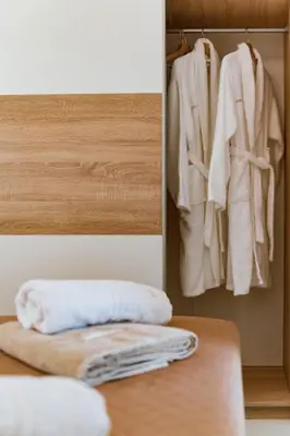 a closet with white towels hanging on a wall at Villa Eventide in Gennadi