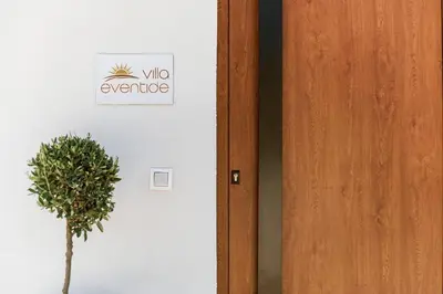 a door with a sign that reads whooperative next to a plant at Villa Eventide in Gennadi