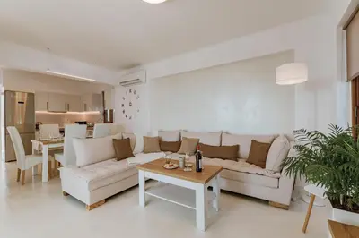 a living room with a white couch and a table at Villa Eventide in Gennadi