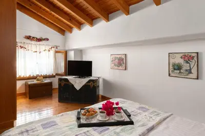 a bedroom with a tray of food on a bed at Little Karafillias Chalki House in Halki