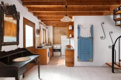 a kitchen with a sink and a blue door at Little Karafillias Chalki House in Halki