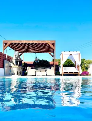 a swimming pool with a gazebo and the water at Kallipateira Villa in Lachania