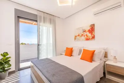a bedroom with a bed and a large window at Kallipateira Villa in Lachania