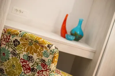 a room with a chair with vases on a shelf at Villa Sophia in Pefki Rhodes