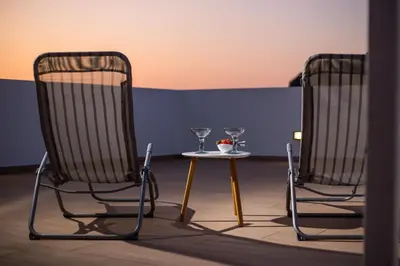 two chairs and a table with glasses on it at Villa Sophia in Pefki Rhodes