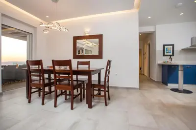 a kitchen and dining room with a table and chairs at Villa Sophia in Pefki Rhodes