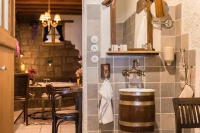 a kitchen with a bar with a barrel on the wall at Koukos Rodos Boutique Hotel & Spa - Adults Only in Rhodes Town