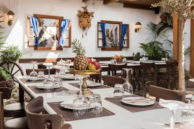 a dining room with tables and chairs with a pineapple centerpiece at Koukos Rodos Boutique Hotel & Spa - Adults Only in Rhodes Town