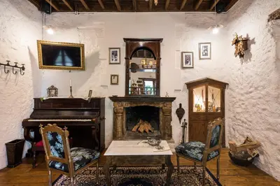 a living room with a piano and a table at Koukos Rodos Boutique Hotel & Spa - Adults Only in Rhodes Town