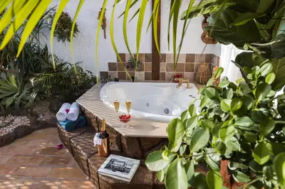 a bath tub in a garden with plants at Koukos Rodos Boutique Hotel & Spa - Adults Only in Rhodes Town