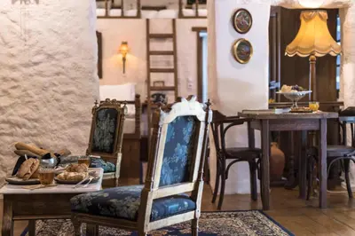 a dining room with two chairs and a table at Koukos Rodos Boutique Hotel & Spa - Adults Only in Rhodes Town