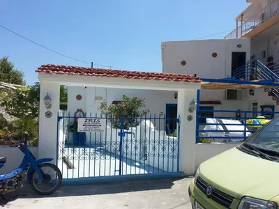 a gate in front of a house with a bike at Iris Studios in Archangelos
