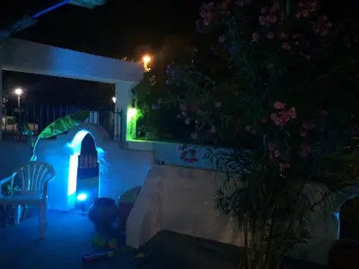 a skateboard ramp in a backyard at night at Iris Studios in Archangelos