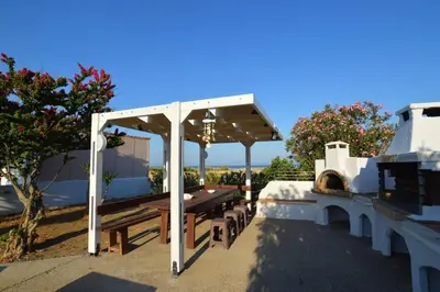 a pavilion with a picnic table and a bench at Renes Paradise Seahome - Afandou Beach, Rhodes in Rhodes Town