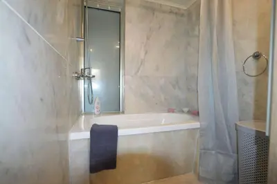 a bathroom with a bath tub and a shower at Renes Paradise Seahome - Afandou Beach, Rhodes in Rhodes Town