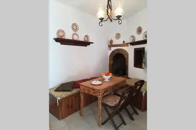 a dining room with a table and a fireplace at Jimmy΄s Place in Gennadi