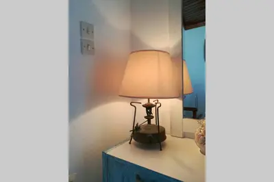 a lamp sitting on a dresser in a room at Jimmy΄s Place in Gennadi