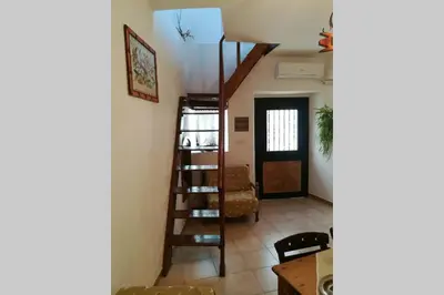 a living room with a ladder and a stair case at Jimmy΄s Place in Gennadi