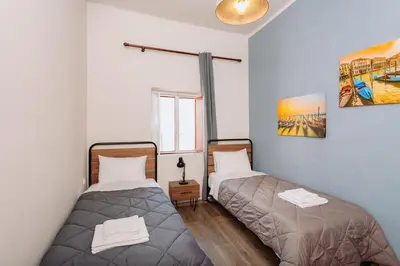 a bedroom with two beds and a window at Rhodes Old town apartment manos in Rhodes Town