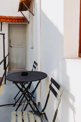 a black table and two chairs on a patio at Rhodes Old town apartment manos in Rhodes Town