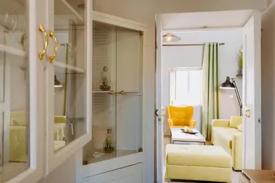 a living room with a yellow chair and a couch at Rhodes Old town apartment manos in Rhodes Town