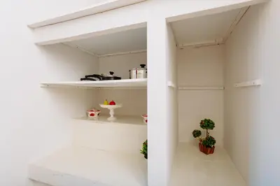 a room with white shelves and potted plants at Rhodes Old town apartment manos in Rhodes Town