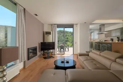 a living room with a couch and a table at Ixian Hilltop Villa in Triánta