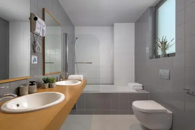 a bathroom with a sink and a tub and a toilet at Ixian Hilltop Villa in Triánta