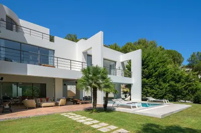 a large white house with a swimming pool at Ixian Hilltop Villa in Triánta