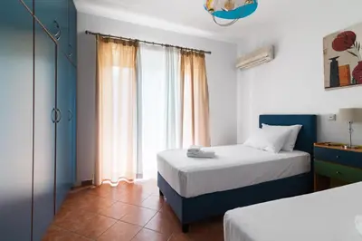 a bedroom with two beds and a window at Villa Del Mar in Ialyssos