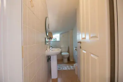 a small bathroom with a sink and a toilet at Villa Del Mar in Ialyssos