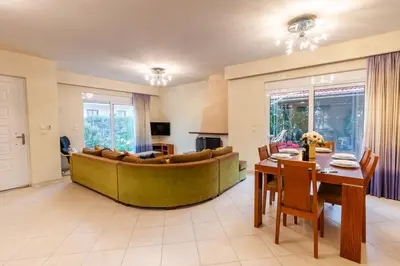 a living room with a couch and a table at Villa Del Mar in Ialyssos