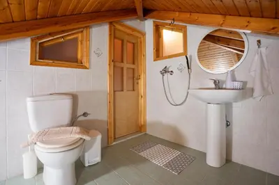 a bathroom with a toilet and a sink at Villa Del Mar in Ialyssos