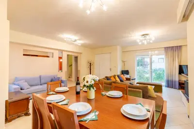 a living room with a table and a couch at Villa Del Mar in Ialyssos