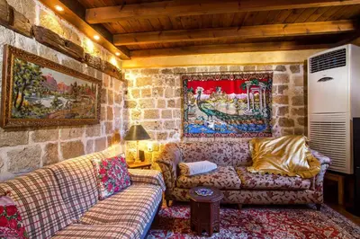 a living room with two couches and a stone wall at CASA DI ALEJANDRO in Rhodes Town
