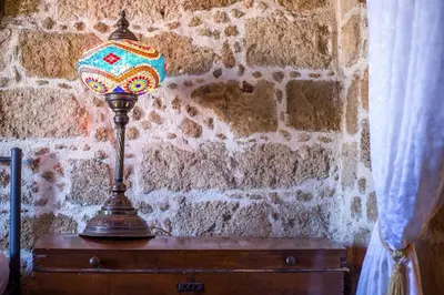 a lamp sitting on top of a wooden chest at CASA DI ALEJANDRO in Rhodes Town