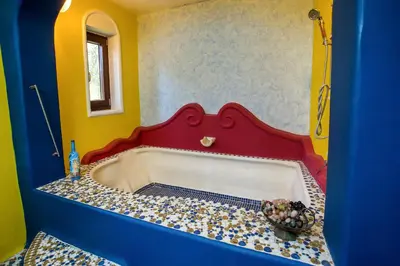 a bath tub in a room with a red and blue wall at CASA DI ALEJANDRO in Rhodes Town