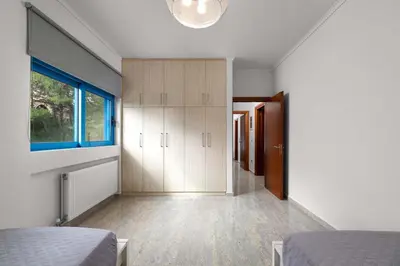 a bedroom with a bed and a large window at Aegean View Estates in Faliraki
