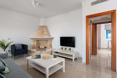 a living room with a couch and a fireplace at Aegean View Estates in Faliraki