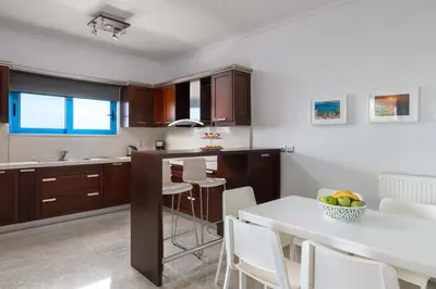 a kitchen with a white table and a dining room at Aegean View Estates in Faliraki
