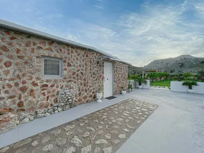 a stone building with a door and a patio at LA Casa Di Lusso N7 -Adults Only in Kolimbia