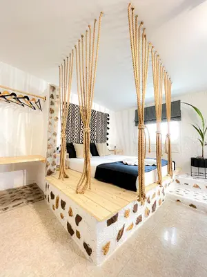 a bedroom with a bed with a wooden swing at LA Casa Di Lusso N7 -Adults Only in Kolimbia