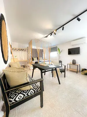 a living room with a table and chairs in it at LA Casa Di Lusso N7 -Adults Only in Kolimbia