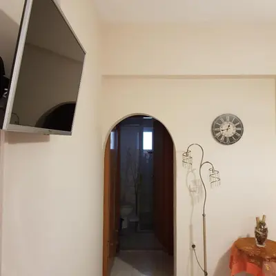 a hallway with a mirror and a clock on the wall at George's & Amalia's appartments 2 in Afantou