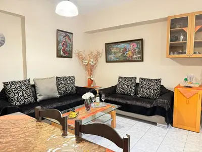 a living room with two couches and a table at George's & Amalia's appartments 2 in Afantou